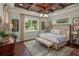 Bedroom with tray ceiling, large bed, and bright natural light from window at 2454 Dream Home Ct, St Cloud, FL 34772