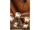 Stunning chandelier with frosted glass shades and a dark bronze finish complements the wood paneled ceiling at 2454 Dream Home Ct, St Cloud, FL 34772