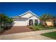 Charming single-story home featuring a brick driveway, lush landscaping, and a welcoming covered entryway at 2454 Dream Home Ct, St Cloud, FL 34772