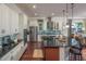 Spacious kitchen with white cabinets, stainless steel appliances, and island with seating at 2454 Dream Home Ct, St Cloud, FL 34772