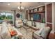 Living room with a decorative television console and sliding glass doors to outdoor patio at 2454 Dream Home Ct, St Cloud, FL 34772