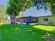 Expansive backyard with a screened-in lanai, mature tree, and plenty of room for outdoor activities at 2817 Prince John Rd, Winter Park, FL 32792