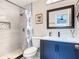 Bathroom featuring a tiled shower, modern vanity with framed mirror, and a decorative shower curtain at 2817 Prince John Rd, Winter Park, FL 32792