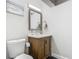 Charming bathroom features a wood vanity, framed mirror, and elegant light fixture at 2817 Prince John Rd, Winter Park, FL 32792