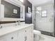Stylish bathroom showcasing a vanity with white marble countertop and a walk-in shower with dark floor tiles at 2817 Prince John Rd, Winter Park, FL 32792