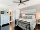 Comfortable bedroom featuring a cozy bed, natural light, and dark wood floors at 2817 Prince John Rd, Winter Park, FL 32792