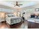Bedroom showcasing natural light, a ceiling fan, and dark wood floors for a warm ambiance at 2817 Prince John Rd, Winter Park, FL 32792