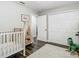 Bright bedroom features a crib and closet with natural light at 2817 Prince John Rd, Winter Park, FL 32792