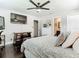 Bedroom featuring a TV, dark wood floors, and ensuite bathroom for added convenience at 2817 Prince John Rd, Winter Park, FL 32792