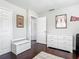 Large bedroom with hardwood floors, natural light, and storage bench at 2817 Prince John Rd, Winter Park, FL 32792