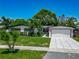 Beautiful single-story home featuring a well-manicured lawn, modern driveway, and charming curb appeal at 2817 Prince John Rd, Winter Park, FL 32792