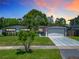 Charming single Gathering home featuring a well manicured lawn and modern driveway at 2817 Prince John Rd, Winter Park, FL 32792