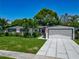 Charming single-story home with a well-manicured lawn and front garden, featuring modern driveway design at 2817 Prince John Rd, Winter Park, FL 32792