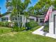 Charming home exterior with lush landscaping, manicured hedges, and a welcoming walkway at 2817 Prince John Rd, Winter Park, FL 32792