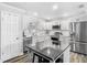 Bright kitchen featuring white cabinets, stainless steel appliances, and central island at 2817 Prince John Rd, Winter Park, FL 32792