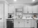Well-appointed kitchen with white cabinets, stainless steel dishwasher, and elegant countertops at 2817 Prince John Rd, Winter Park, FL 32792