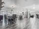 Open-concept living area featuring a modern kitchen, dining area, and wood-look tile flooring at 2817 Prince John Rd, Winter Park, FL 32792