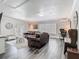 The open-concept living room features modern decor, grey wood-look floors, and abundant natural light at 2817 Prince John Rd, Winter Park, FL 32792