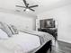 Cozy bedroom features a ceiling fan, dark wood floors, and ample closet space at 2817 Prince John Rd, Winter Park, FL 32792