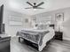 Cozy bedroom features a ceiling fan, dark wood floors, and natural light at 2817 Prince John Rd, Winter Park, FL 32792