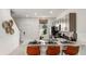 Modern kitchen with stainless steel appliances, quartz countertops, and seating at the island at 3082 Skyline Loop, Kissimmee, FL 34758