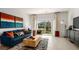 Bright living room with stylish furniture, neutral walls, and large sliding doors leading to outdoor space at 3086 Skyline Loop, Kissimmee, FL 34758