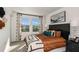 Cozy bedroom with a comfortable bed, neutral decor, and a window view at 3090 Skyline Loop, Kissimmee, FL 34758