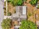 An aerial view of a single-story home with a gray roof, complemented by lush trees and landscaping at 3218 Cimarron Dr, Orlando, FL 32829