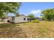 View of the backyard with chainlink fence, grass, and a view of the screen patio at 3218 Cimarron Dr, Orlando, FL 32829