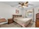 Bright bedroom with wood-look ceiling fan, natural light, and wood trim at 3218 Cimarron Dr, Orlando, FL 32829