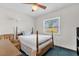 Bright bedroom featuring a window, a bed, and a ceiling fan at 3218 Cimarron Dr, Orlando, FL 32829