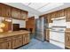 A kitchen featuring a refrigerator, vintage appliances, and a view of the office at 3218 Cimarron Dr, Orlando, FL 32829
