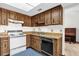 Efficient kitchen with wood cabinets, updated appliances, and skylight at 3218 Cimarron Dr, Orlando, FL 32829