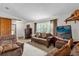 Cozy living room featuring a large window, comfortable seating, and vintage decor at 3218 Cimarron Dr, Orlando, FL 32829