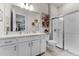 Modern bathroom featuring dual sinks, vanity with stone countertop and a glass-enclosed shower at 3417 Michigan St, Lake Mary, FL 32746