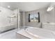 Bright bathroom featuring a walk-in shower, soaking tub, and a dual sink vanity with modern fixtures at 3417 Michigan St, Lake Mary, FL 32746