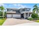Attractive two-story home featuring a three-car garage, brick driveway, and lush front lawn at 3417 Michigan St, Lake Mary, FL 32746