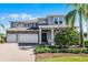 Beautiful two-story home with stone accents, well-manicured landscaping, and a three-car garage at 3417 Michigan St, Lake Mary, FL 32746