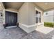 Charming front door and porch area with brick pavers, potted plants, and detailed trim at 3417 Michigan St, Lake Mary, FL 32746