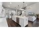 Spacious kitchen with an island, stainless appliances, white cabinets, and an open view to the living room at 3417 Michigan St, Lake Mary, FL 32746