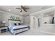Spacious main bedroom featuring a decorative headboard, soft lighting, and access to an en-suite bathroom at 3417 Michigan St, Lake Mary, FL 32746
