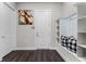 Welcoming mudroom featuring wood floors, a built-in bench with storage, and stylish decor for an organized entry at 3417 Michigan St, Lake Mary, FL 32746