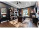 Elegant office with custom built-ins, tray ceilings, a large window, and hardwood floors at 3417 Michigan St, Lake Mary, FL 32746