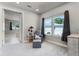Bright sitting room features a comfortable chair, side table, and ample natural light from a large window at 3417 Michigan St, Lake Mary, FL 32746