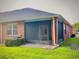 Cozy screened-in back porch with brick siding and a well-maintained lawn, creating a private retreat at 3461 Home Town Ln, St Cloud, FL 34769