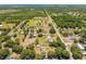 Wide aerial shot showing property with road access and neighboring houses at 3975 Rambler Ave, St Cloud, FL 34772