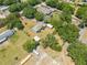 Aerial view of a home on a spacious lot with trees, outbuildings, and greenery at 3975 Rambler Ave, St Cloud, FL 34772