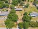 Aerial view of a house and outbuildings on a property with trees and green lawns at 3975 Rambler Ave, St Cloud, FL 34772