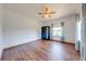 Bedroom featuring wood-look floors, a ceiling fan, a closet, and a window at 3975 Rambler Ave, St Cloud, FL 34772