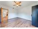 Bright bedroom featuring wood-look floors, a ceiling fan, and a glimpse into other rooms at 3975 Rambler Ave, St Cloud, FL 34772